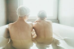 Two people relaxing in a bathtub